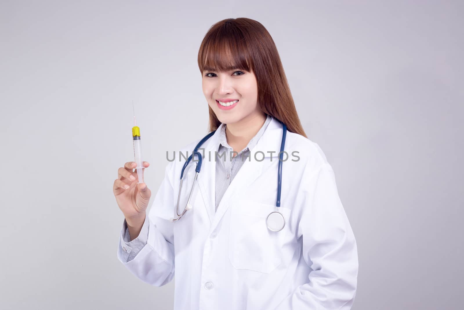 Healthy concept : Young Asian doctor with hypodermic syringe in hand