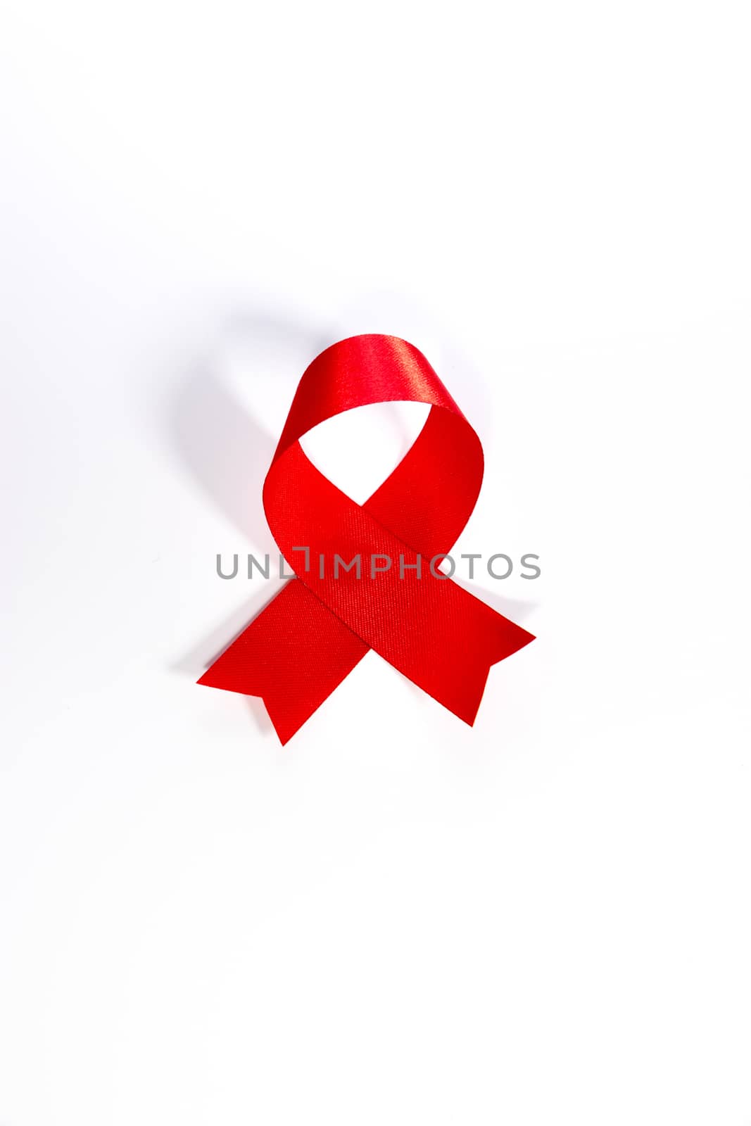 World aids day.Red Aids ribbon.World AIDS Day 1 December. Red AIDS ribbon isolated on white background with shadow. AIDS icon.AIDS awareness. HIV & STI. AIDS logo. AIDS symbol. HIV symbol.HIV disease. by asiandelight