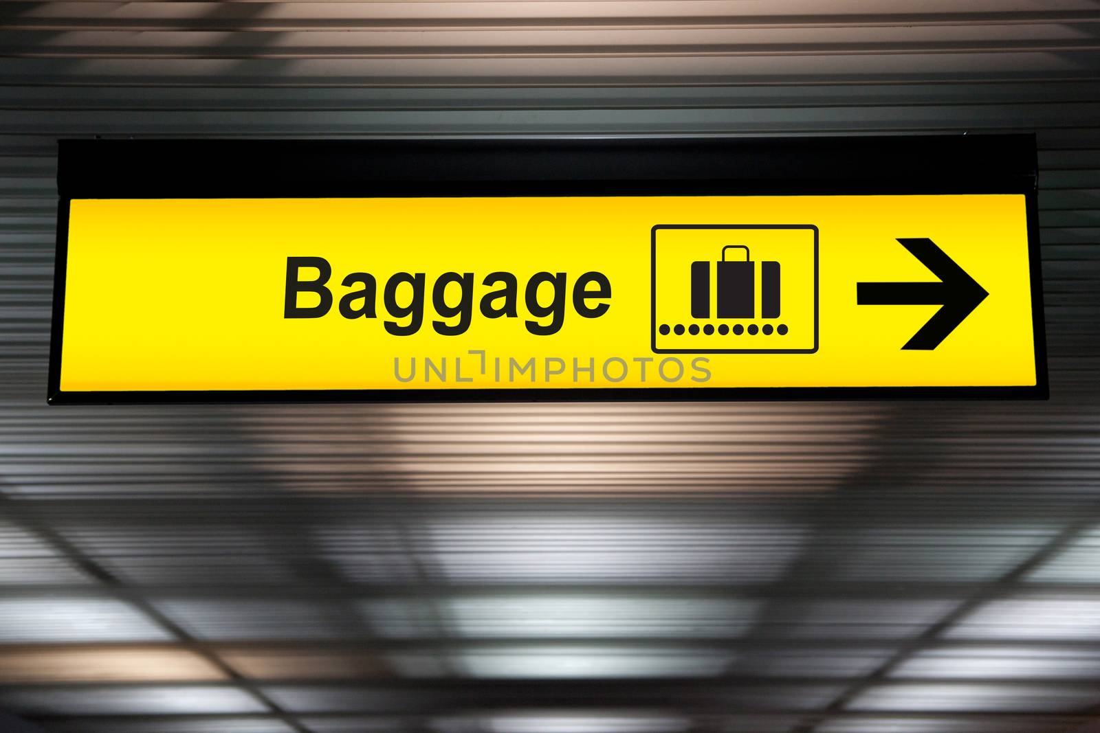 baggage airport signs hanging from ceiling from airport terminal