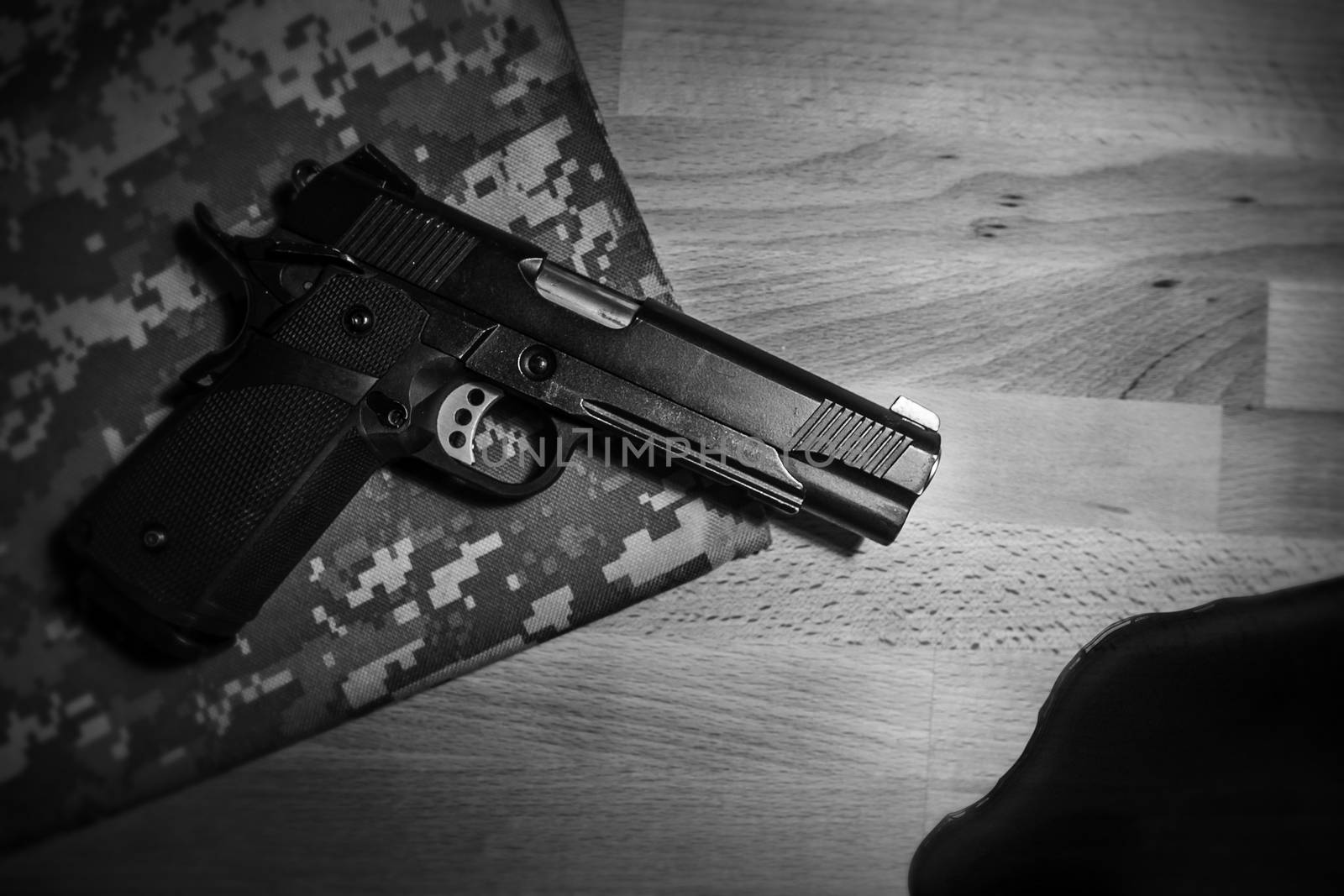 gun and blood on wooden table. black and white. robbery, murder, crime and security concept by asiandelight