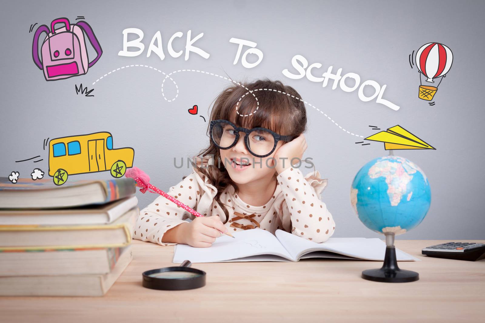back to school  concept. cute little girl wear glasses do homework at home with word back to school and cute cartoon on head. learning, teaching and education educate children by asiandelight