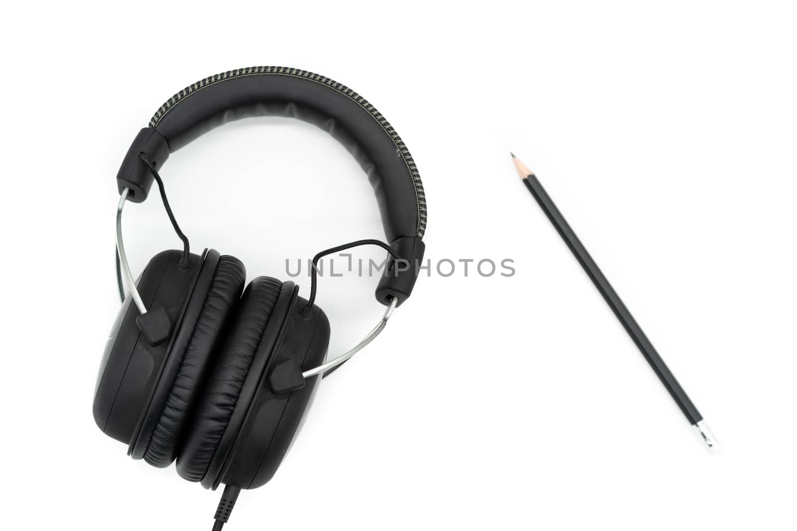 The black pencil is on the right side of the picture, the headphones are on the left side of the picture, all on a white background.