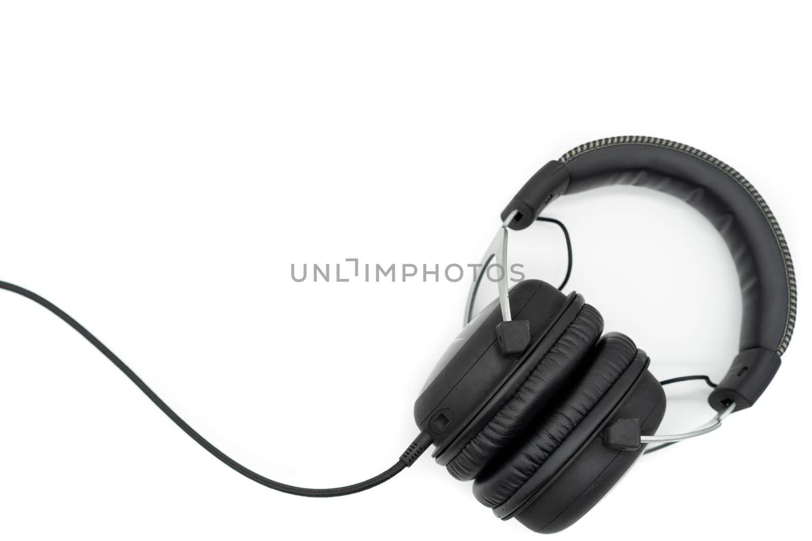 The black headphones place the bottom left hand corner of the image on a white background.