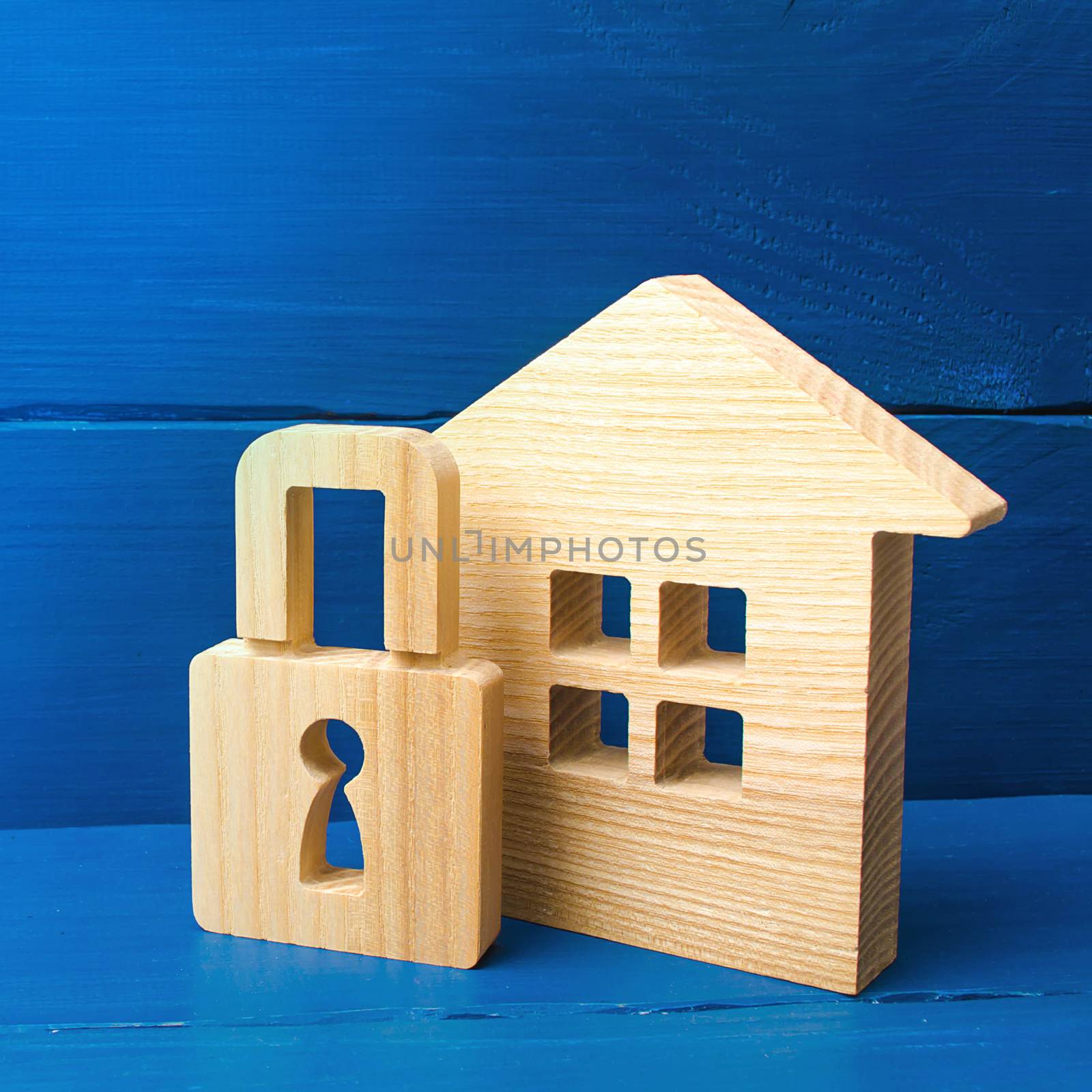 Wooden house with a padlock. Buying a home. House with a lock. Security and safety, collateral, loan for a mortgage. Confiscation of property for debts. Safety and alarm system.