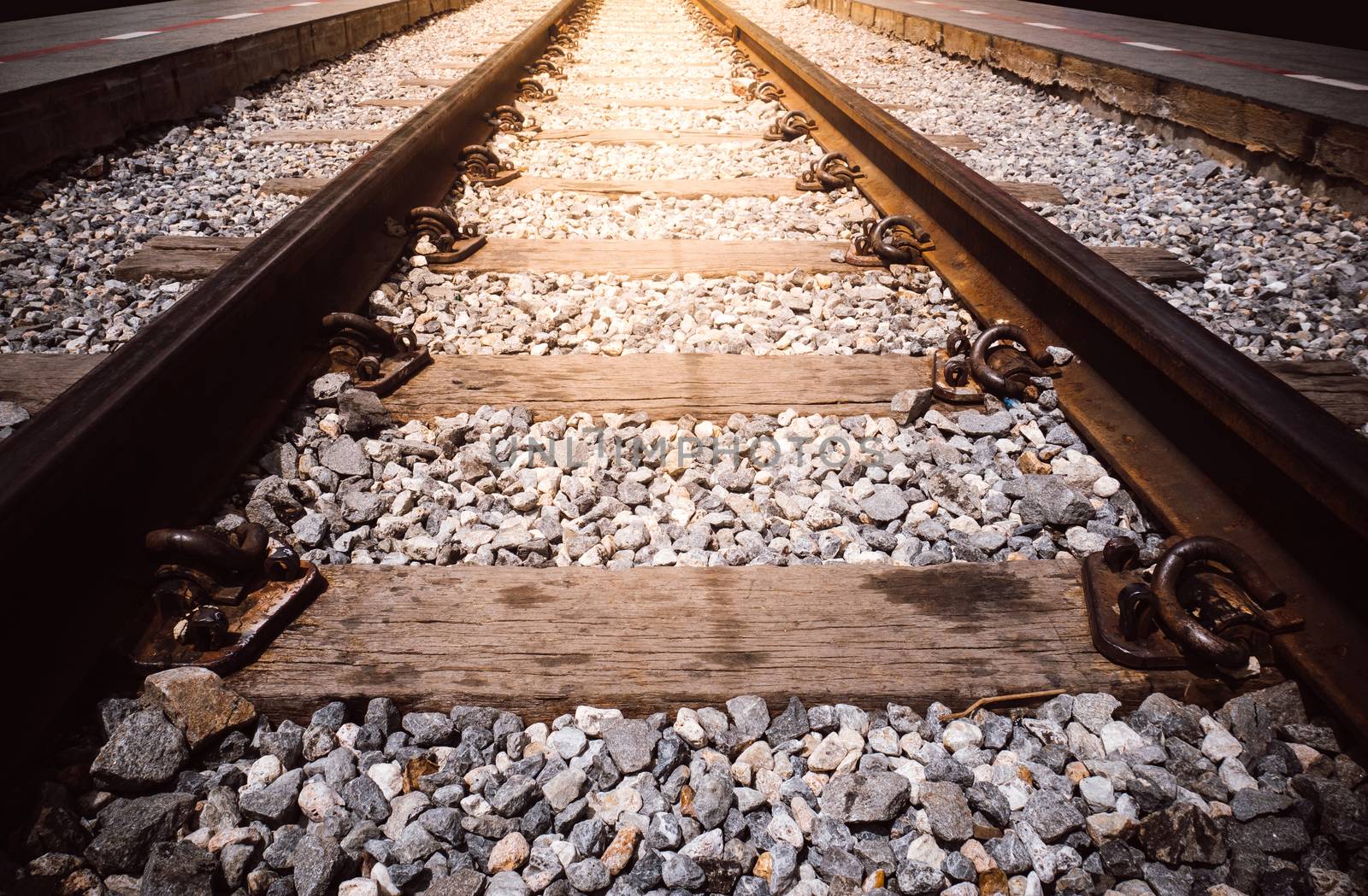 close up railway tracks with light effect. transportation by train on railway concept