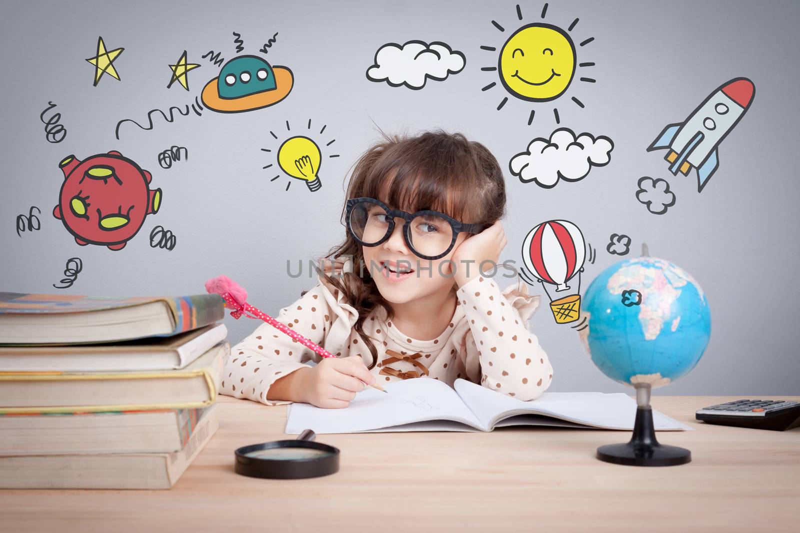 education concept , cute little happy girl at school making homework with creativity