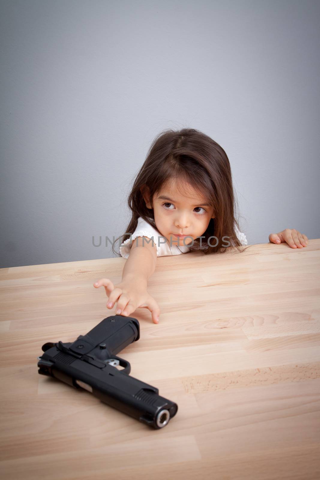 parents not keep gun in safe place, children can have gun for accident. safety concept by asiandelight