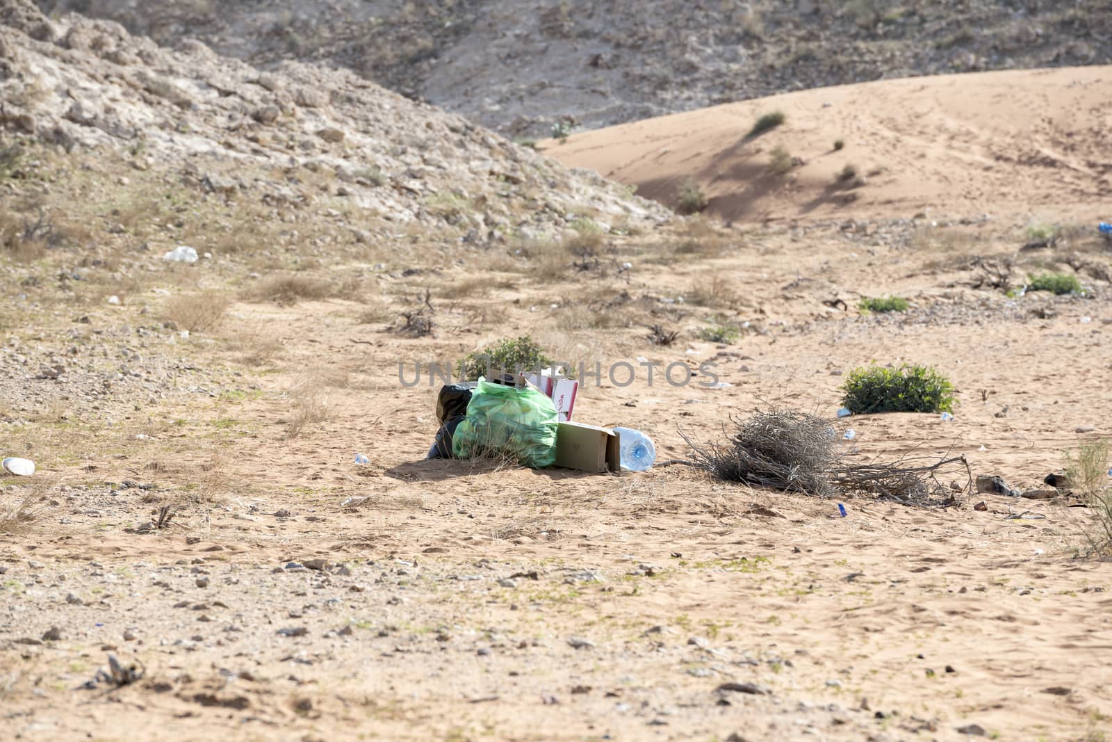 Garbage left in Desert (plastic bag, plastic bottles, cartoons and other detritus). Plastic pollution and environmental issue