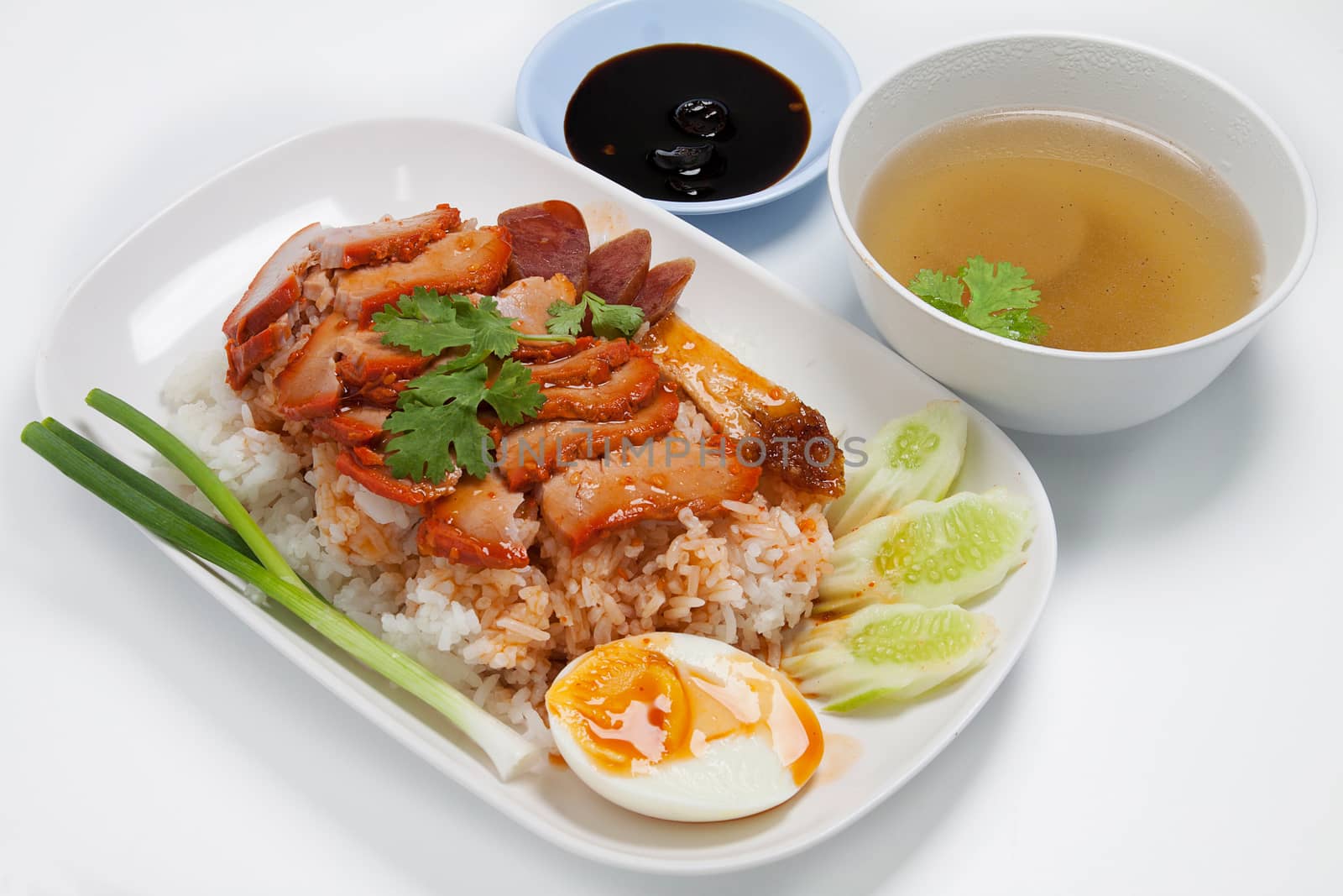 Barbecued red pork in sauce with rice, Chinese style roasted pork.