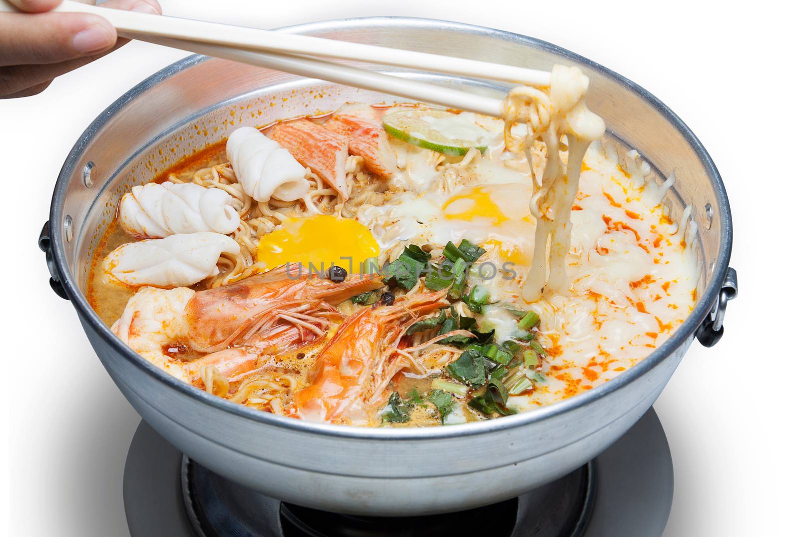 Pot of spicy instant noodles with Cheese isolated on white background. Topping with egg , seafood , shrimp, Squid, crab ,lemon and coriander.Chopsticks by asiandelight