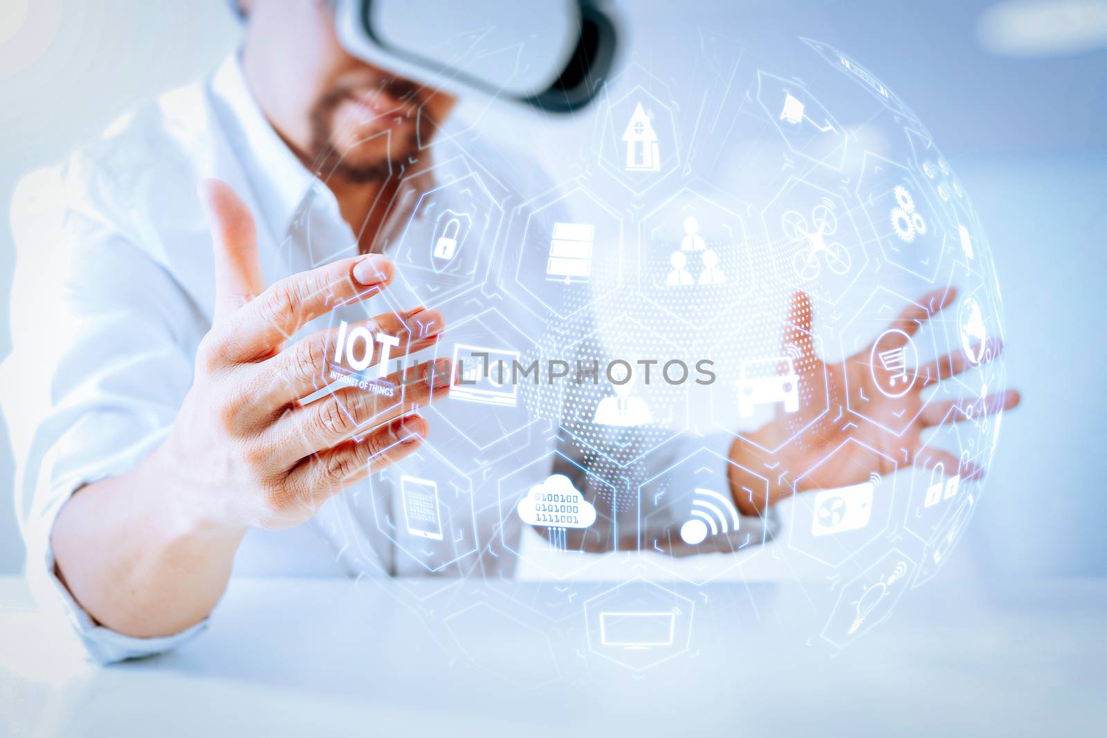Internet of Things (IOT) technology with AR (Augmented Reality) on VR dashboard.businessman wearing virtual reality goggles in modern office with Smartphone using with VR headset