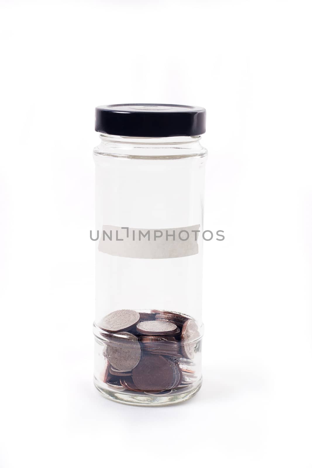 Coins in glass jar on white background for money saving financial concept