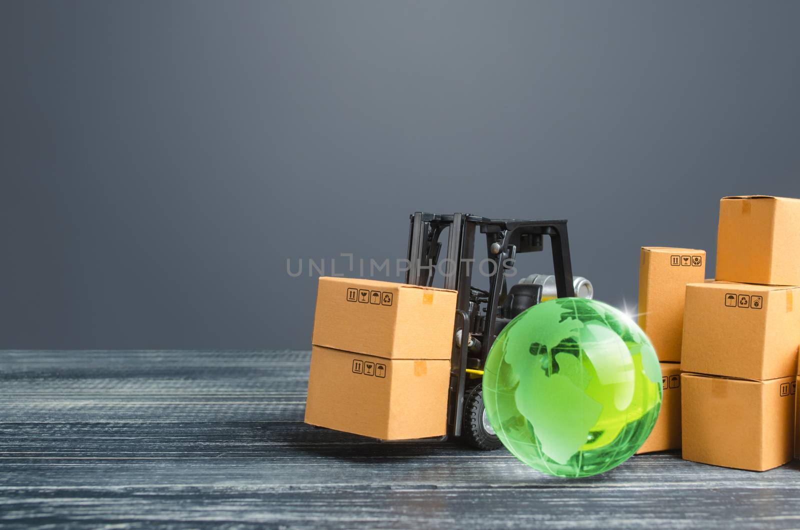 Green glass globe and forklift truck with cardboard boxes. Distribution and trade exchange goods around the world, retail and sales. Global business, import, export. Economic relations. Freight by iLixe48