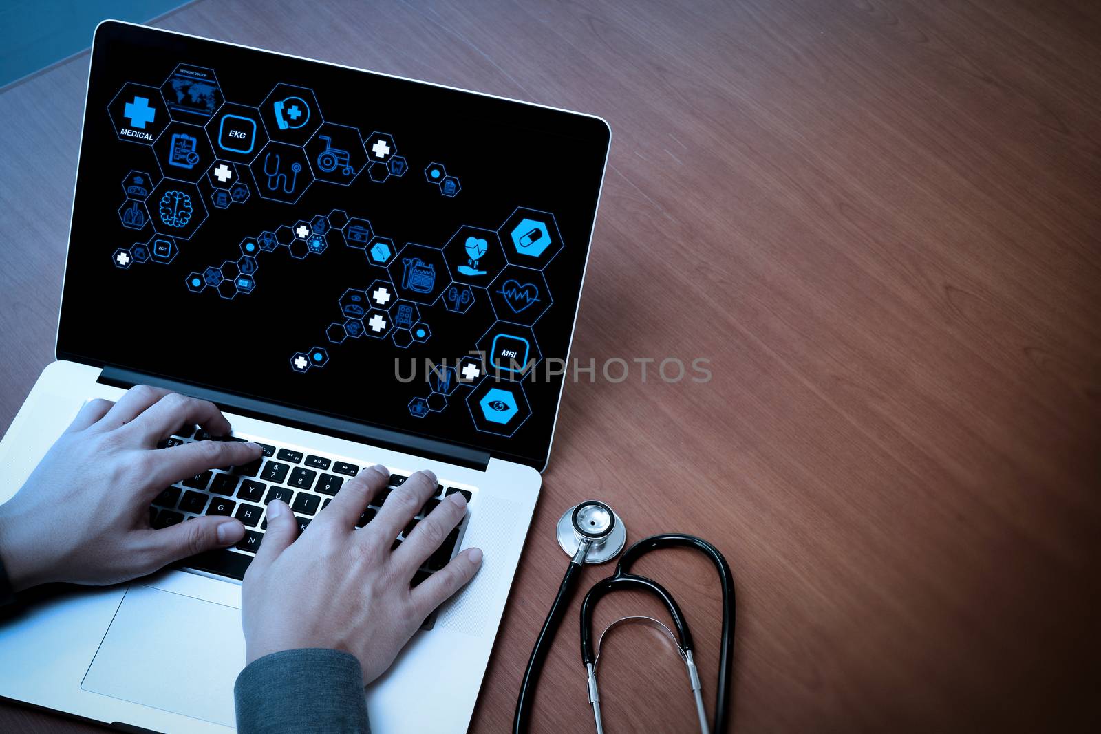 Health care and medical technology services concept with flat line AR interface.Medicine doctor hand working with modern computer and blank screen on wooden desk as medical concept                          