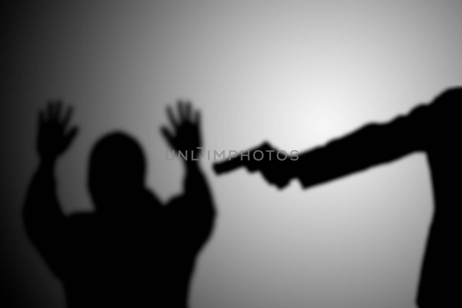 Man with gun point to victim's head. black and white. robbery, murder, crime and security concept. by asiandelight