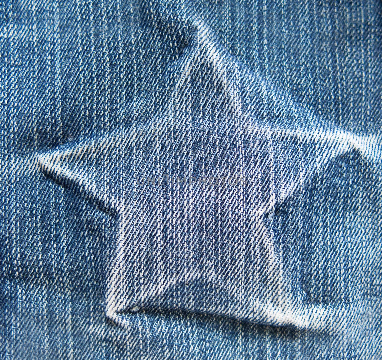 star on denim texture. light blue natural clean denim texture for the traditional business background in cold bright colors with diagonal shift tilt lines and stitches
