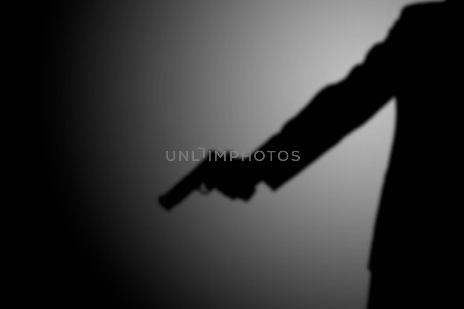 Killer shooting a gun. black and white. robbery, murder, crime and security concept by asiandelight