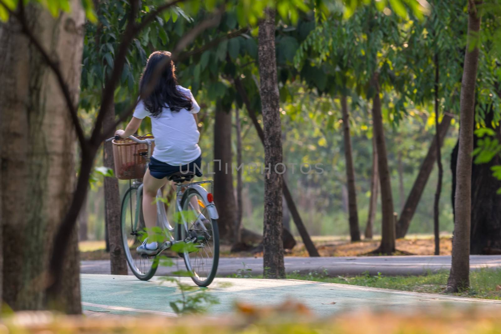 People cycling bicycle in park for exercise by PongMoji