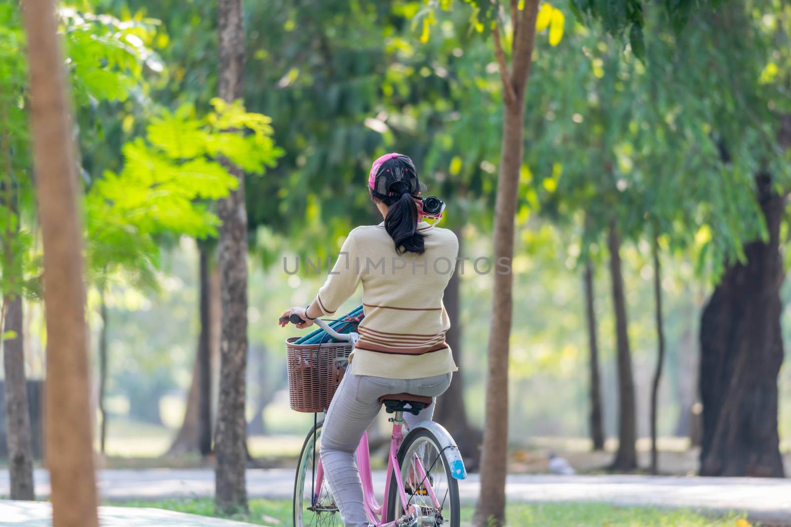 People cycling bicycle in park for exercise by PongMoji