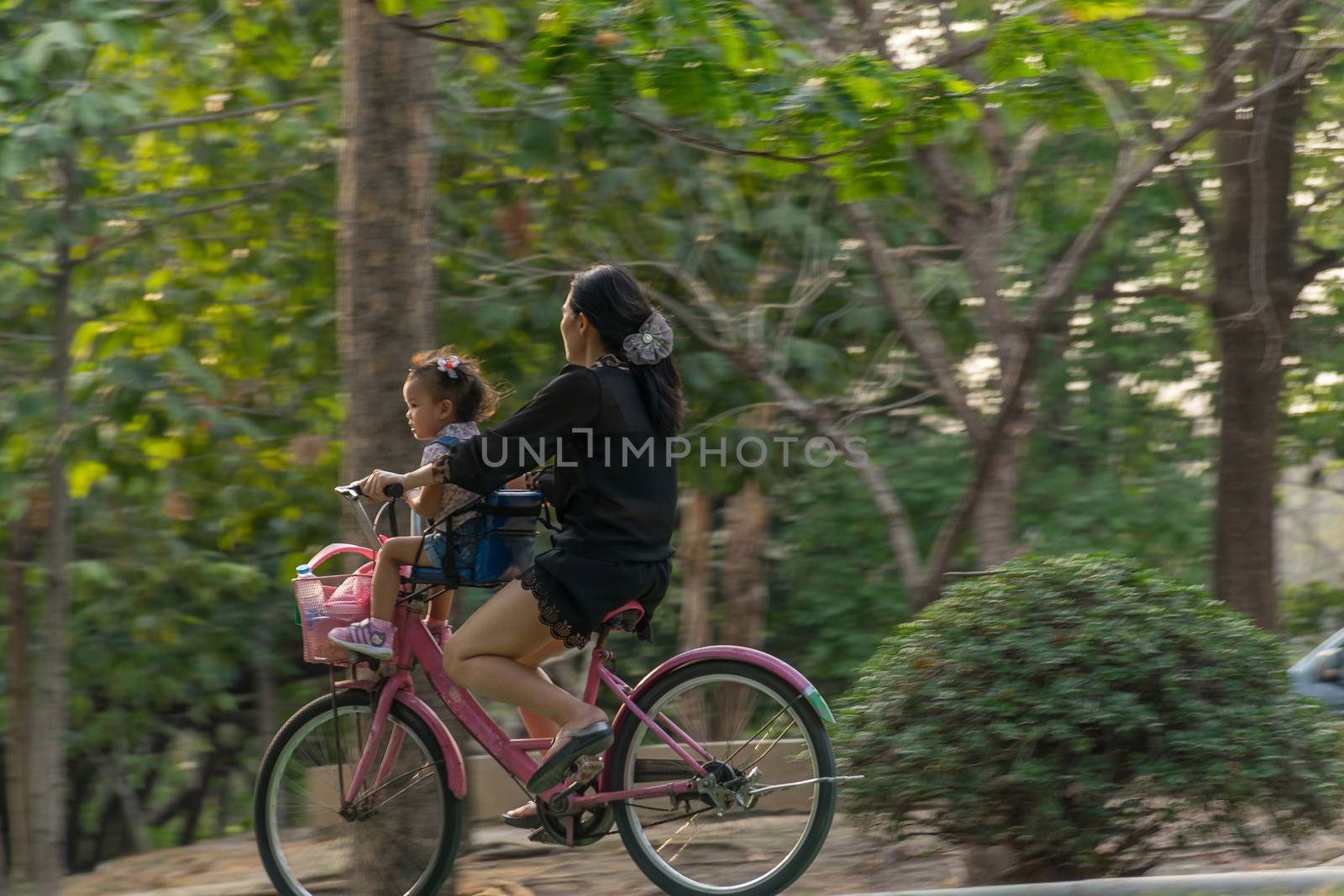 Bangkok, Thailand - March 15, 2017 : Unidentified people riding a bicycle by cycling on a bicycle lane in a outdoor park for exercise healthy