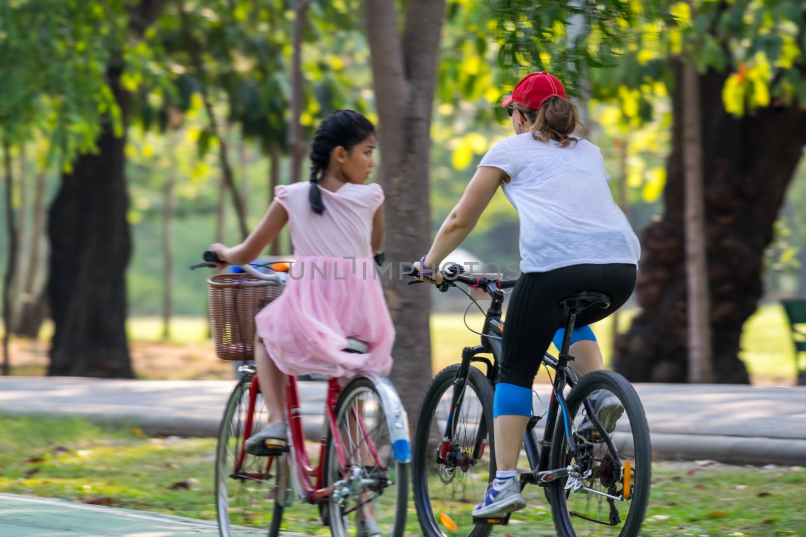 Bangkok, Thailand - March 15, 2017 : Unidentified people riding a bicycle by cycling on a bicycle lane in a outdoor park for exercise healthy