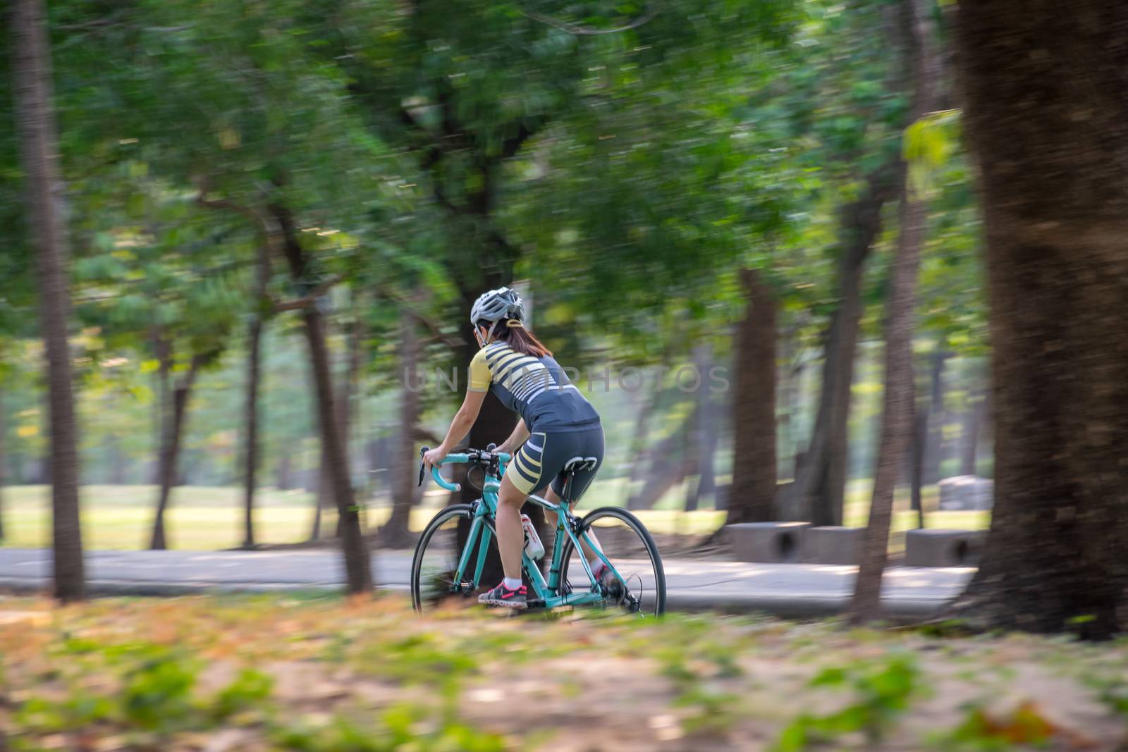 People cycling bicycle in park for exercise by PongMoji