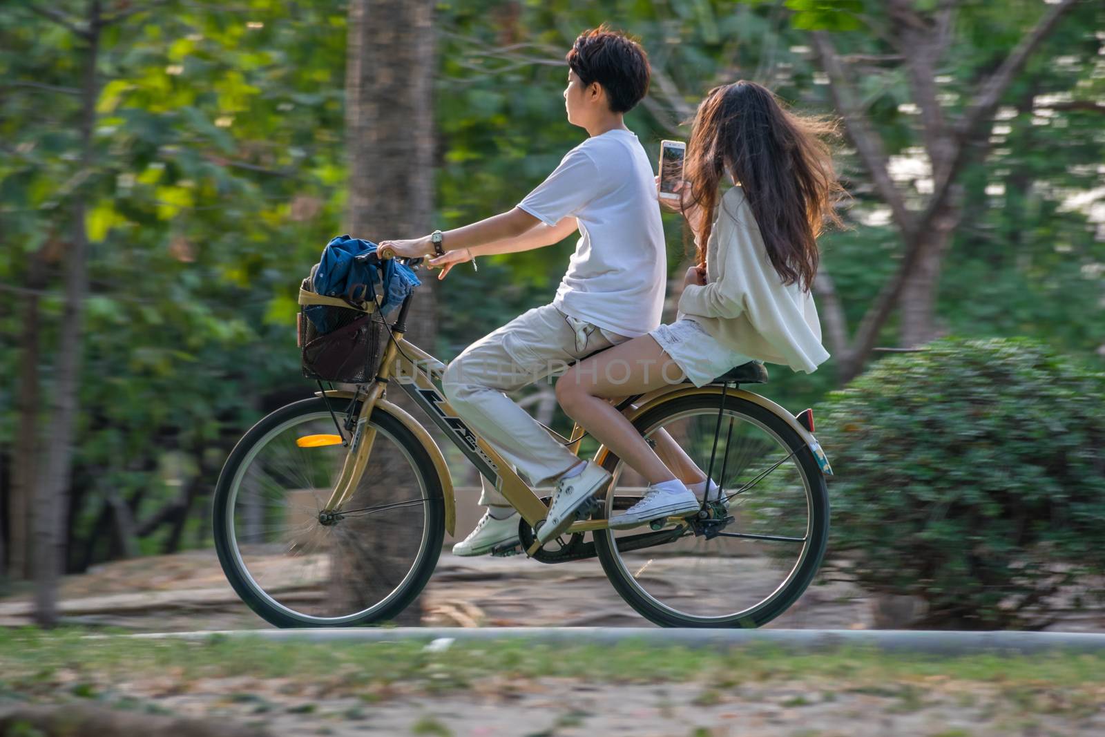 Bangkok, Thailand - March 15, 2017 : Unidentified people riding a bicycle by cycling on a bicycle lane in a outdoor park for exercise healthy