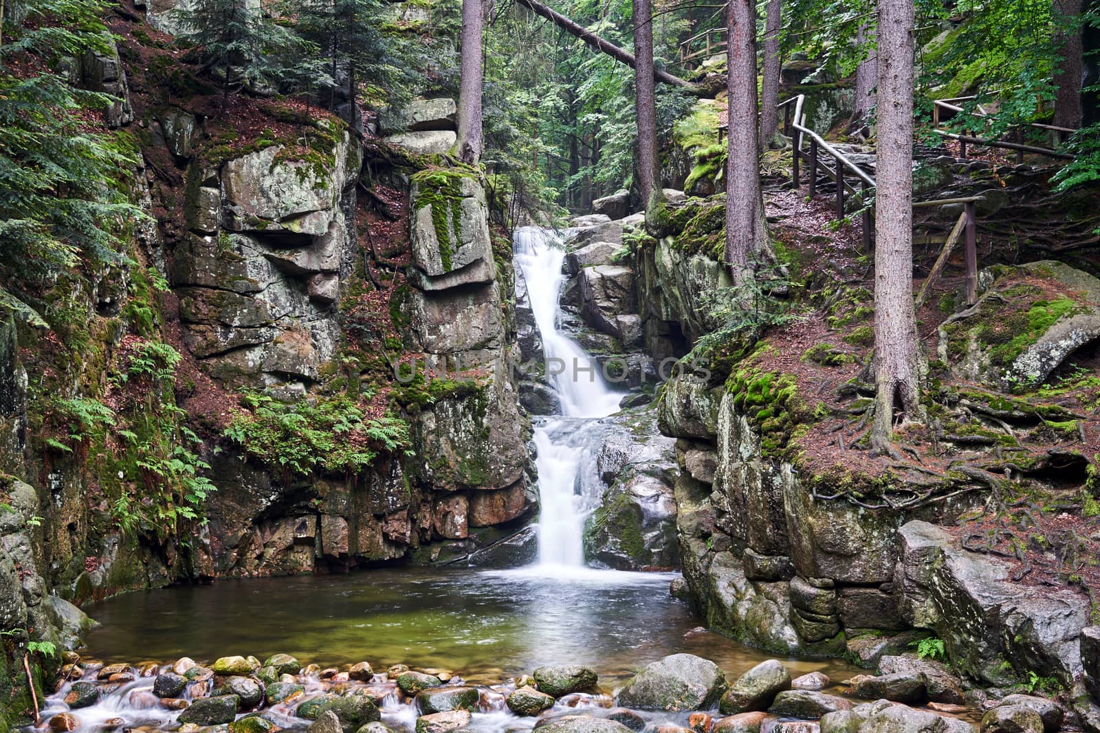 Rocks and boulders in the mountain stream in the forest in the Giant Mountains in Poland