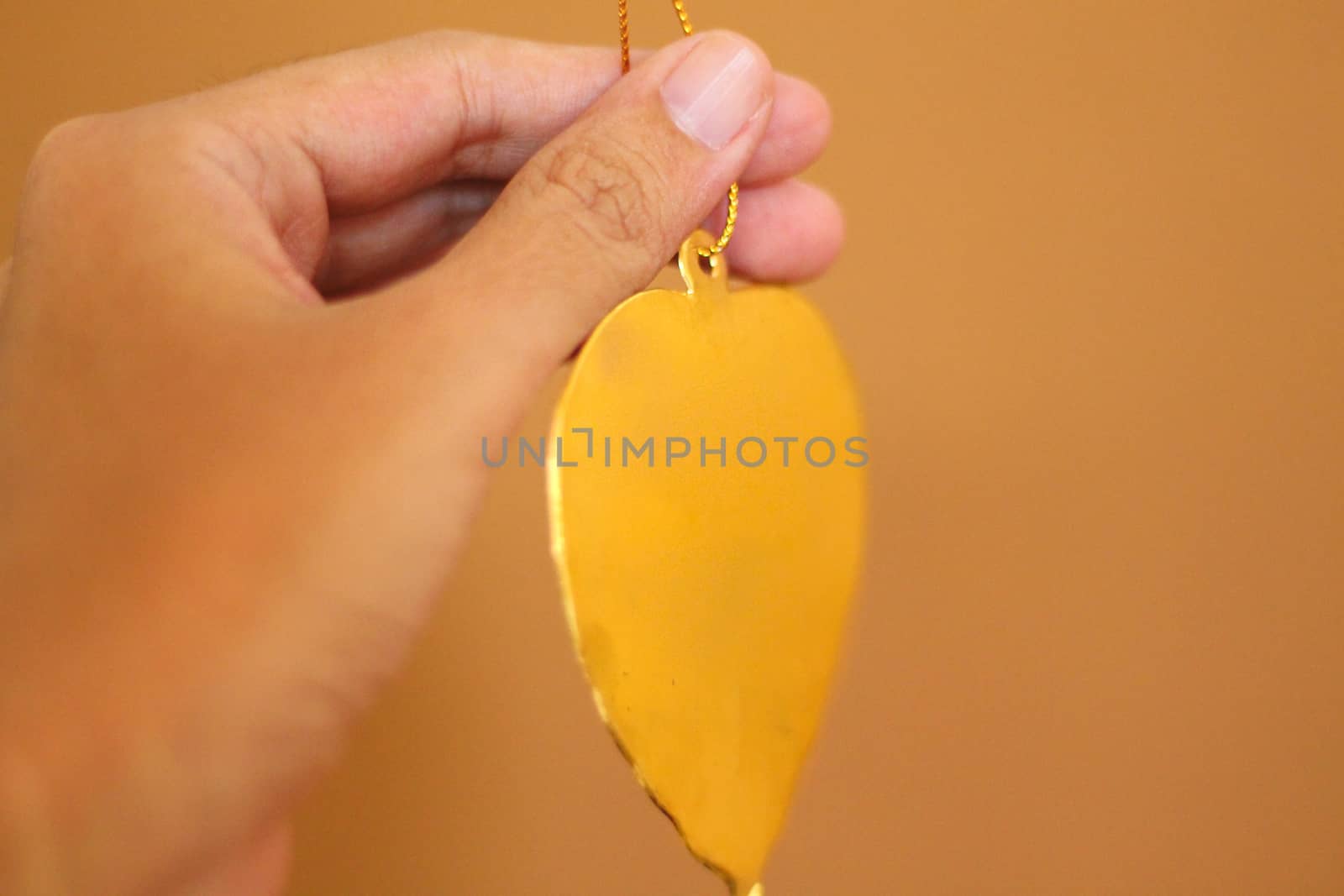 Golden leaf thai religious offering called wai phra in Buddhist religion