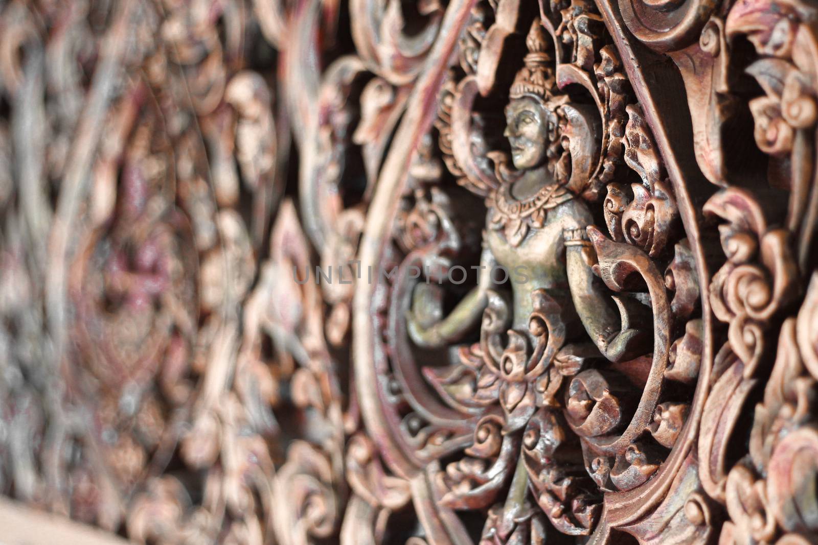 Elaborate traditional thai wall design of an Apsara Dancer in Wat Arun temple in Bangkok, Thailand