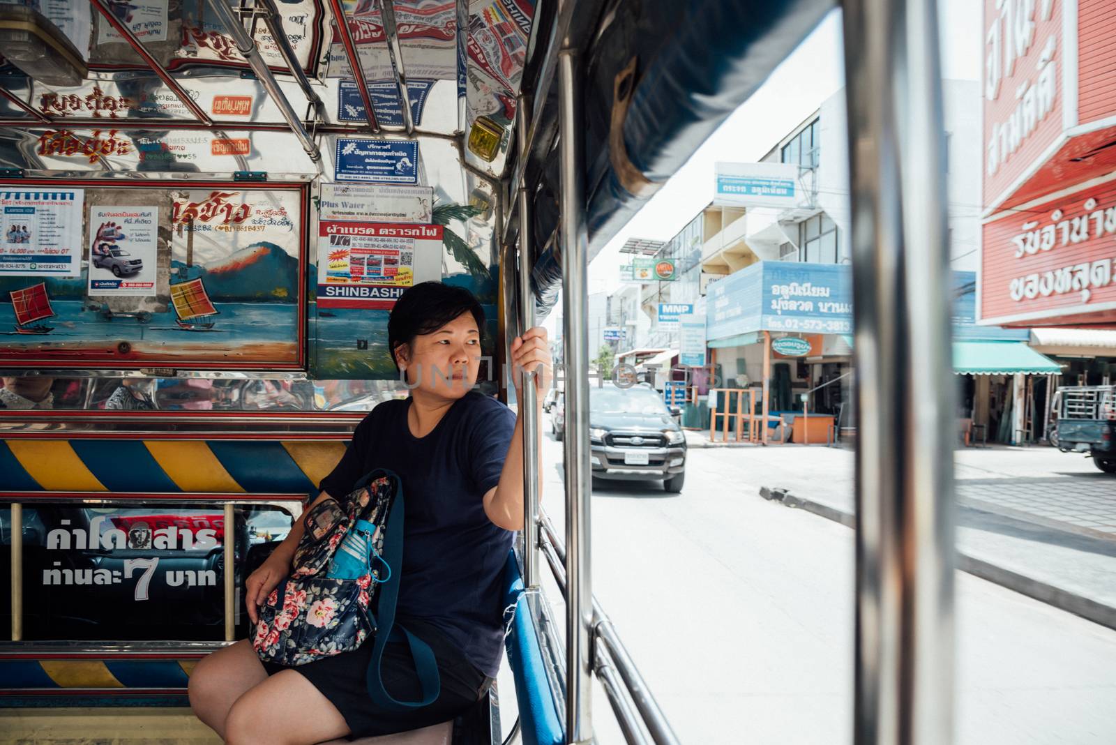Bangkok, Thailand - June 10, 2017 : Asia women 40s white skin prepare a fare on a minibus car for a passenger travel in city to destination