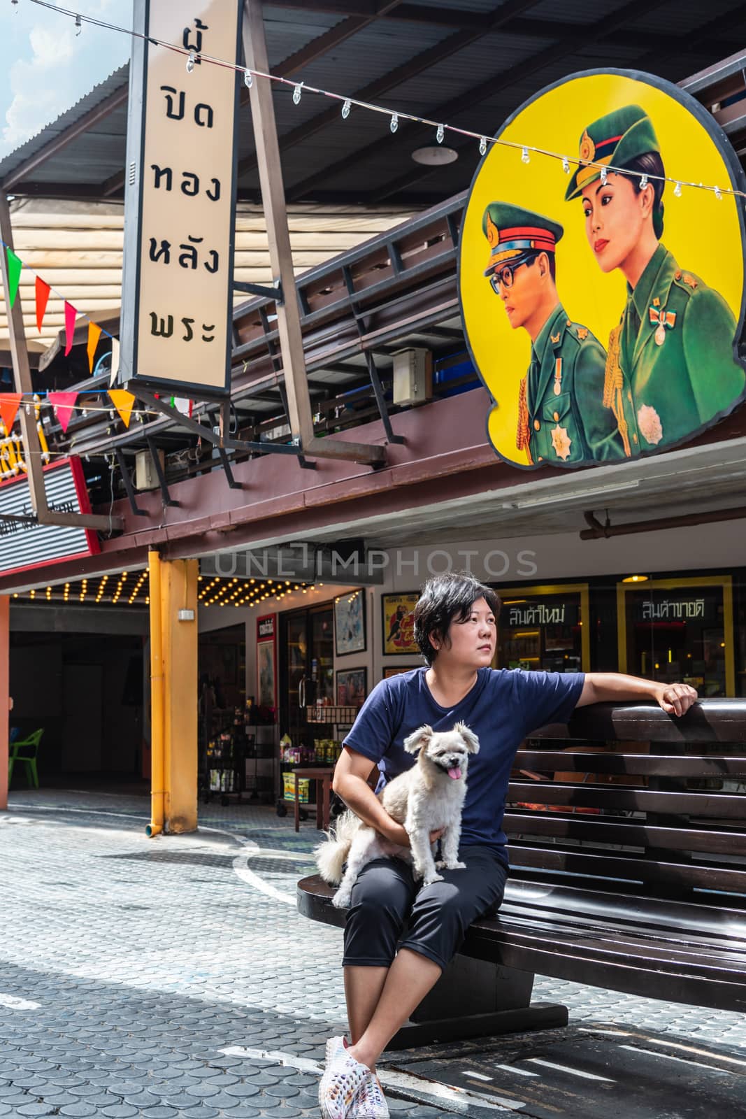 Prachuap Khiri Khan, Thailand - June 18, 2017 : Asian and her dog travel at Mercado de Plearnwan is tourist attraction in Hua Hin recreated retro village plus charming colorful accommodations.