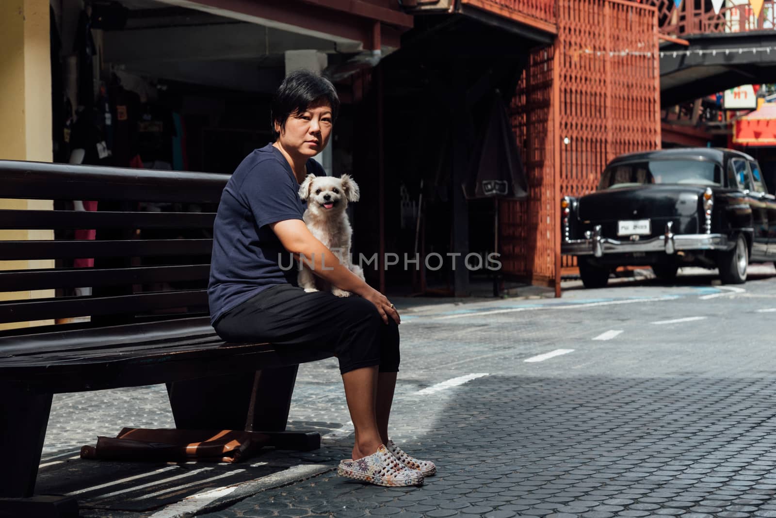 Prachuap Khiri Khan, Thailand - June 18, 2017 : Asian and her dog travel at Mercado de Plearnwan is tourist attraction in Hua Hin recreated retro village plus charming colorful accommodations.