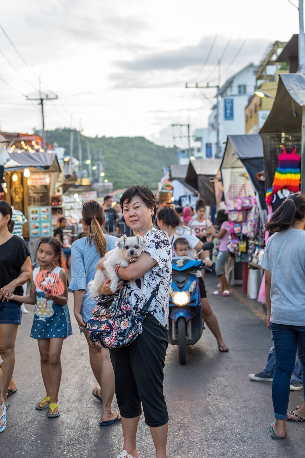 Prachuap Khiri Khan, Thailand - June 17, 2017 : Unidentified woman and the dog walk stroll shopping at Hua Hin night market. The famous night market for travel in Hua Hin is major tourist attraction.