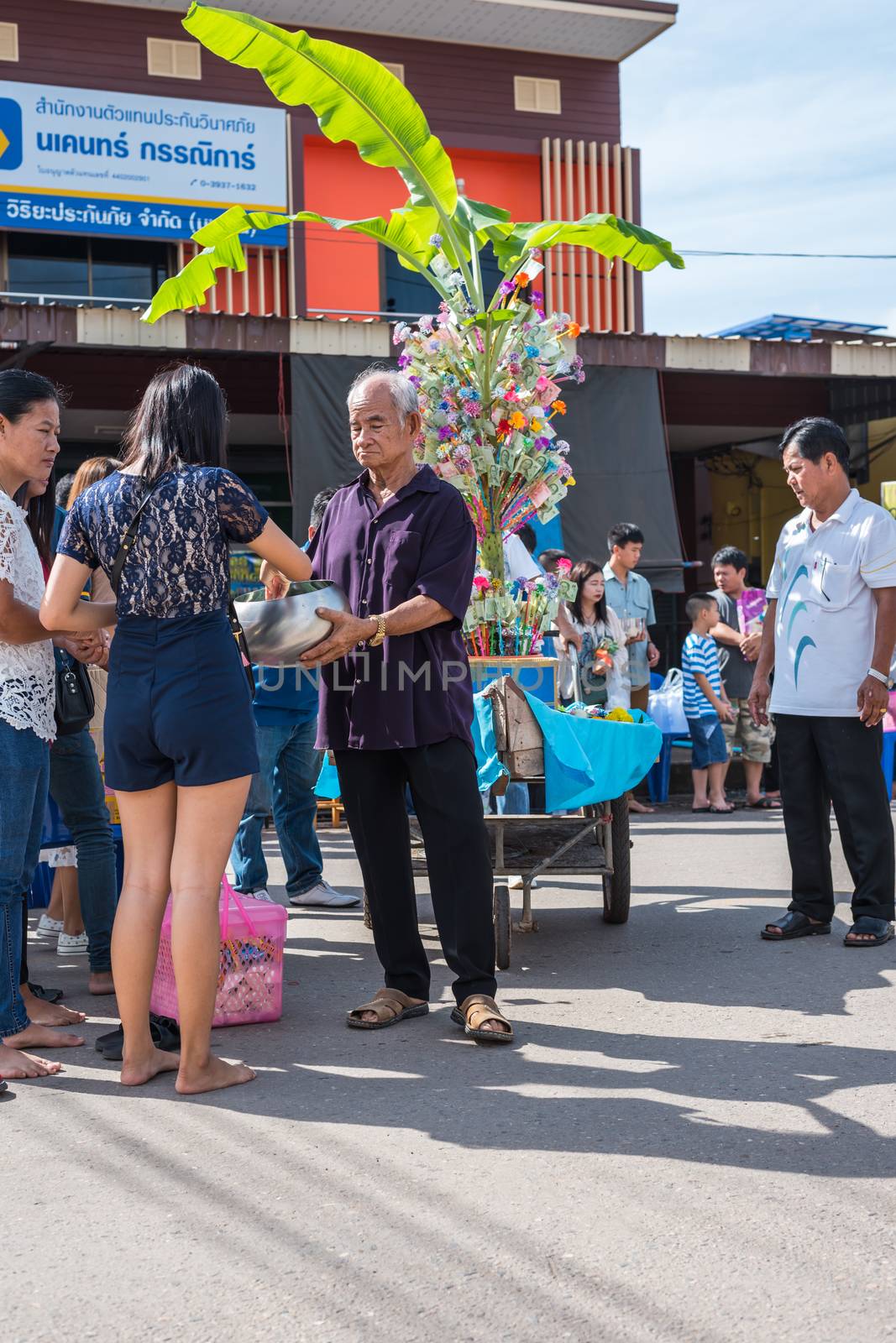 Chanthaburi, Thailand - July 9, 2017 : Unidentified Thai buddhism people in buddhist pray by Kathin Ceremony to make and off-season offering of robes and other needs to monks at Thai temple (Wat Thai)