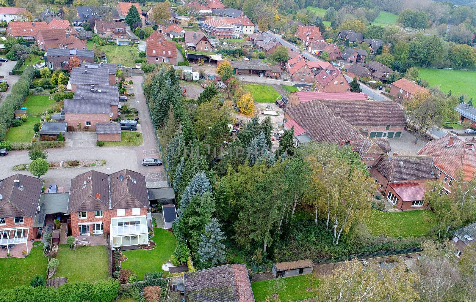  Suburban settlement in Germany with terraced houses, home for many families, aerial photograph taken at a slanting angle with the drone