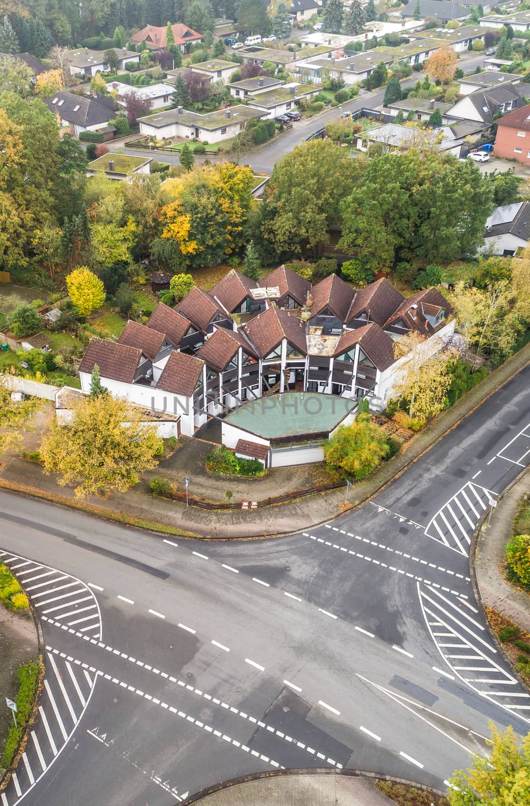 Modern terraced house with central forecourt in a suburb of Germany, aerial view with drone, taken at a slanting angle