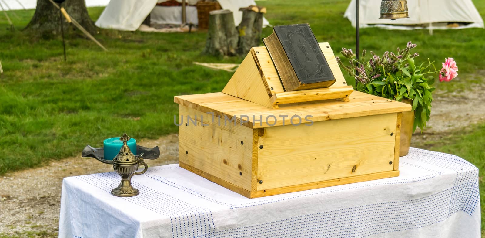 Christian open-air church, table as pulpit with an old bible, outside church, simple church