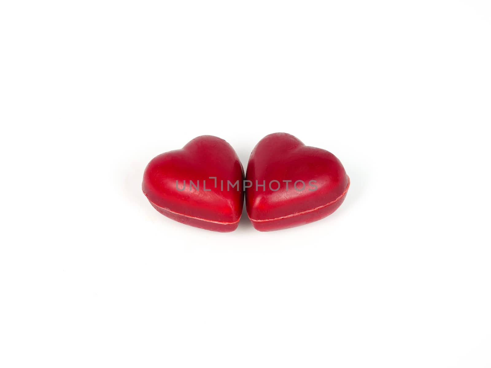 two heart shape chocolate candies, isolated on white background