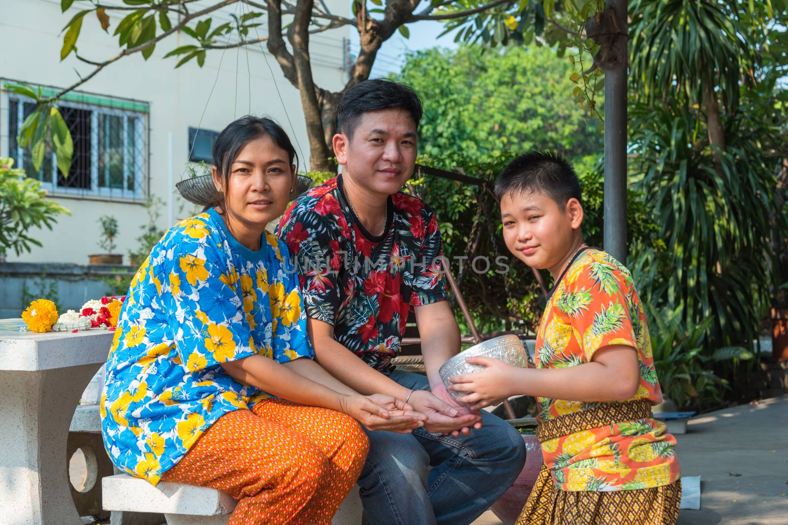 Ang Thong, Thailand - April 13, 2018 : Unidentified Asian young bathe with respect to parents by water have a jasmine and rose flower and aromatherapy in water in water bowl in Songkran Festival