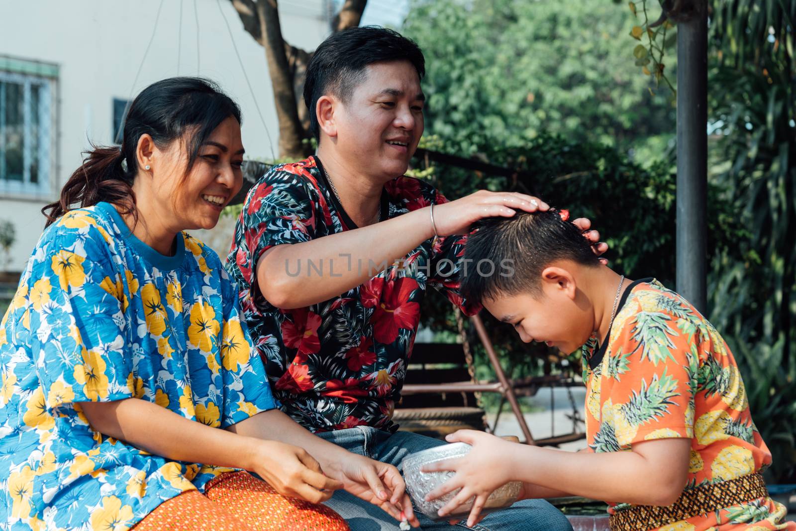 Ang Thong, Thailand - April 13, 2018 : Unidentified Asian young bathe with respect to parents by water have a jasmine and rose flower and aromatherapy in water in water bowl in Songkran Festival