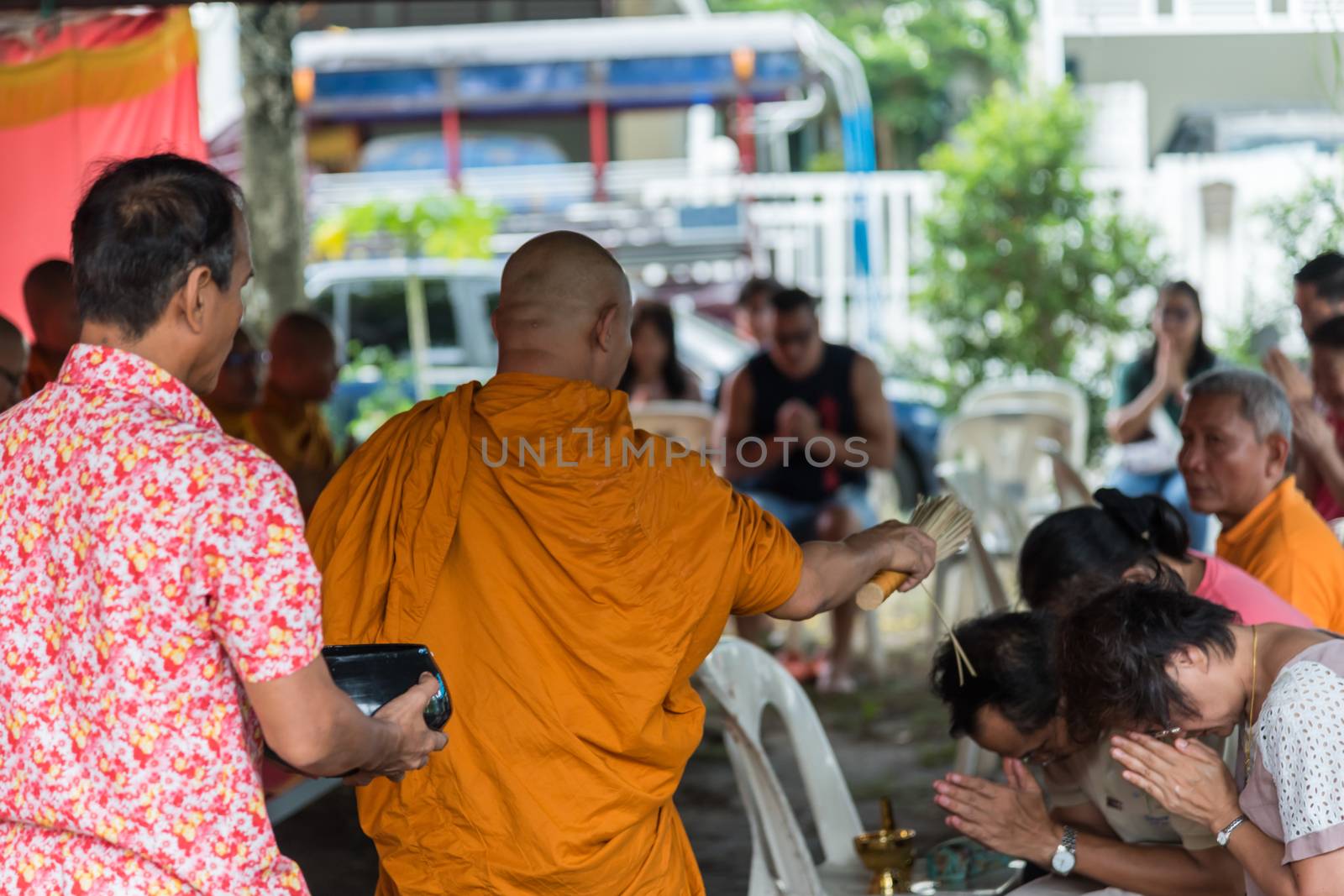 Bangkok, Thailand - April 29, 2018 : Unidentified thai monk praying and bless by holy water for religious ceremony in buddhist belief at Thai temple (Wat Thai)