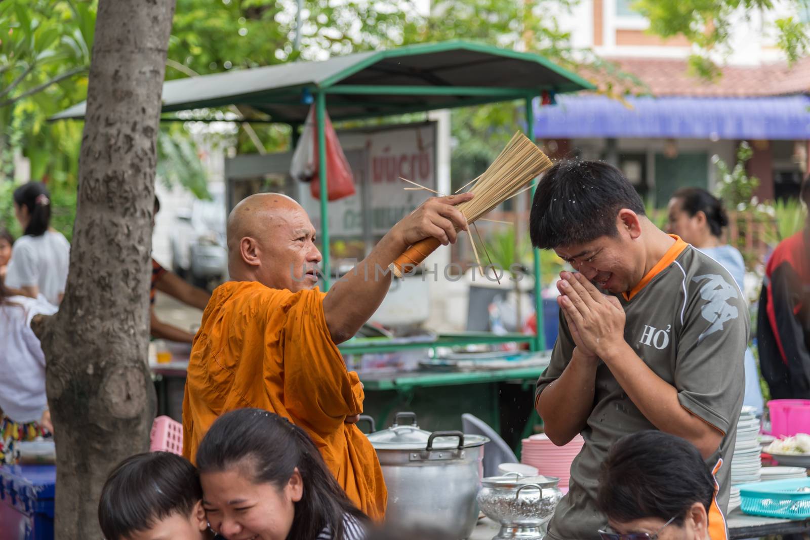 Bangkok, Thailand - April 29, 2018 : Unidentified thai monk praying and bless by holy water for religious ceremony in buddhist belief at Thai temple (Wat Thai)