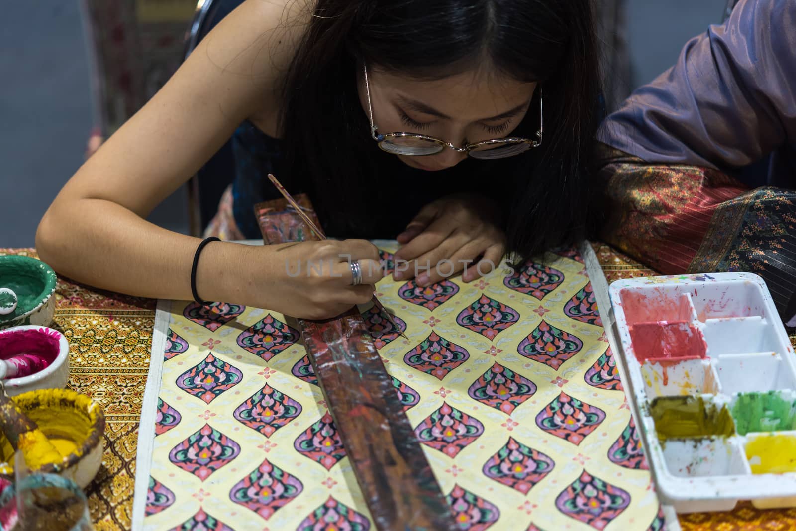 Bangkok, Thailand - June 16, 2018 : Unidentified Thai artist drawing a striped Thai art for making Thai silk design by Ayutthaya traditional contemporary fashion