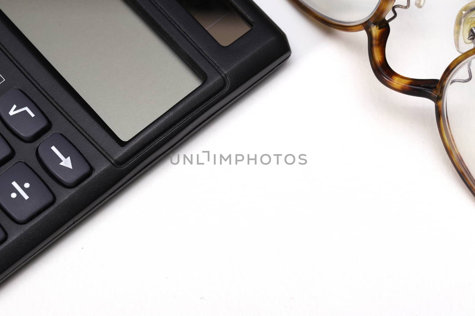 a calculator and a pair of glasses isolated on white background