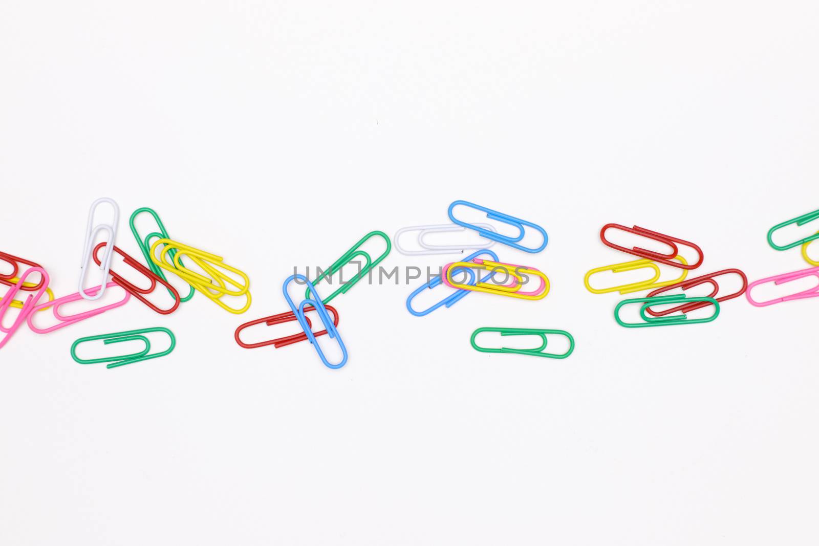 colorful paperclips on white office desk