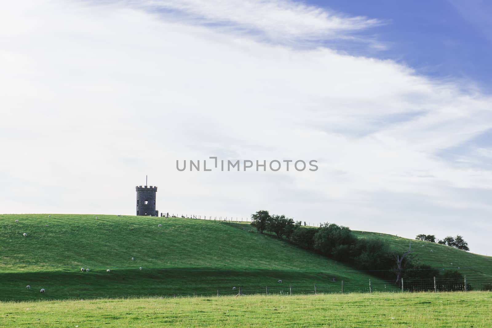 St Anthony Tower Milnthopre with open fields and blue sky
