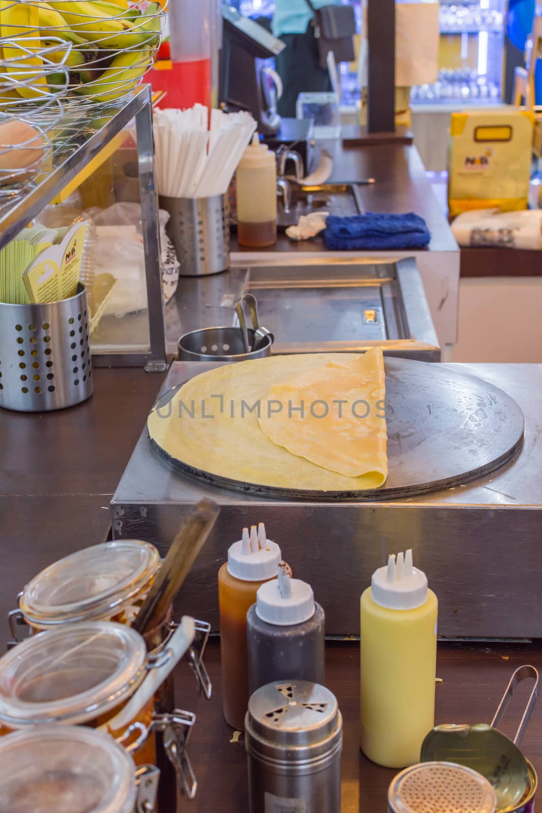 Bangkok, Thailand -  June 5, 2016 : Unidentified chef cooking a crepe is a sweet food for sale at Thai street dessert food market.