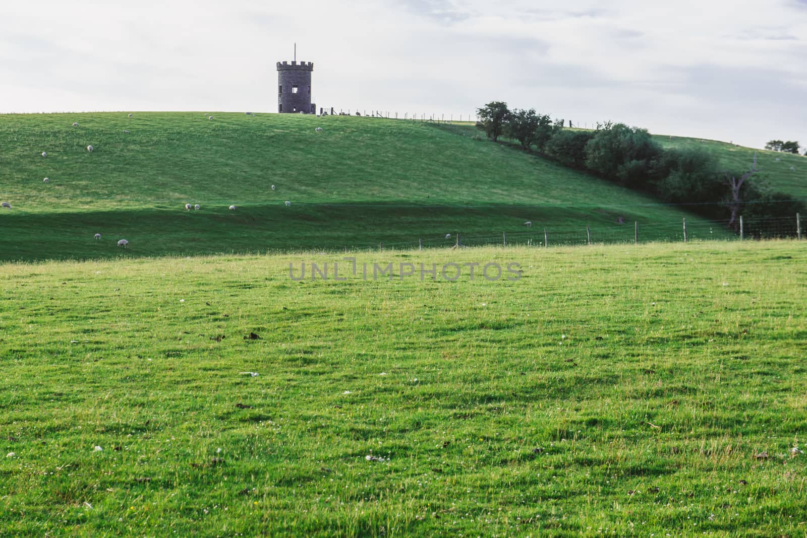 St Anthony Tower Milnthopre with open fields and blue sky