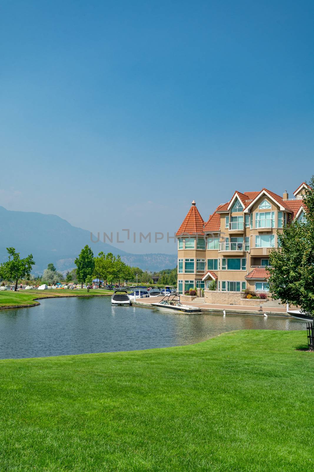 Luxury residential building with boat pier at the entrance. House at waterfromt in British Columbia